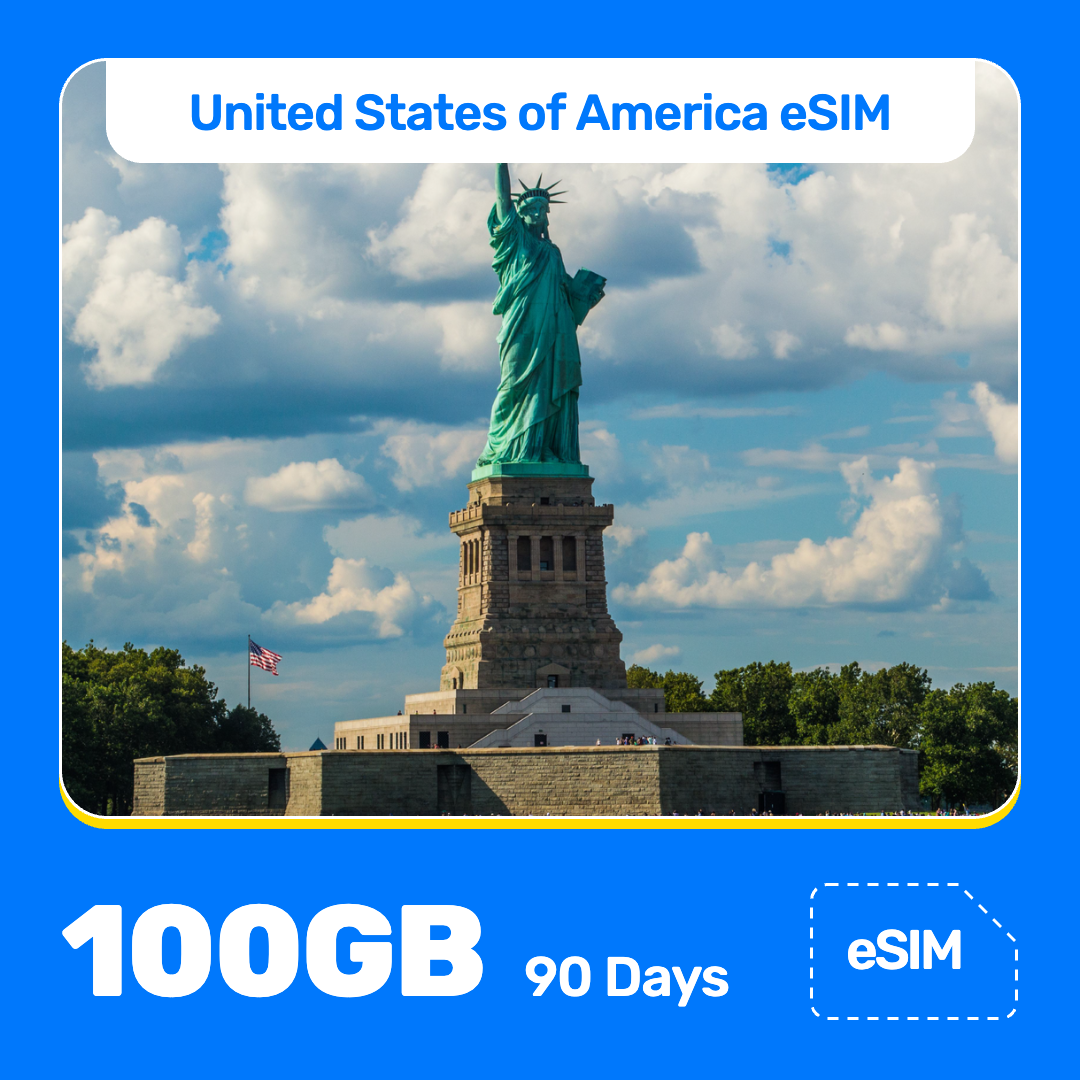 USA eSIM product banner featuring the Statue of Liberty on an island in New York Harbor on a sunny day, with visitors along the shore, and American flag nearby. Blue “USA eSIM” text appears at the top, with large white “100GB for 90 Days” text at the bottom left and an “eSIM” label at the bottom right.