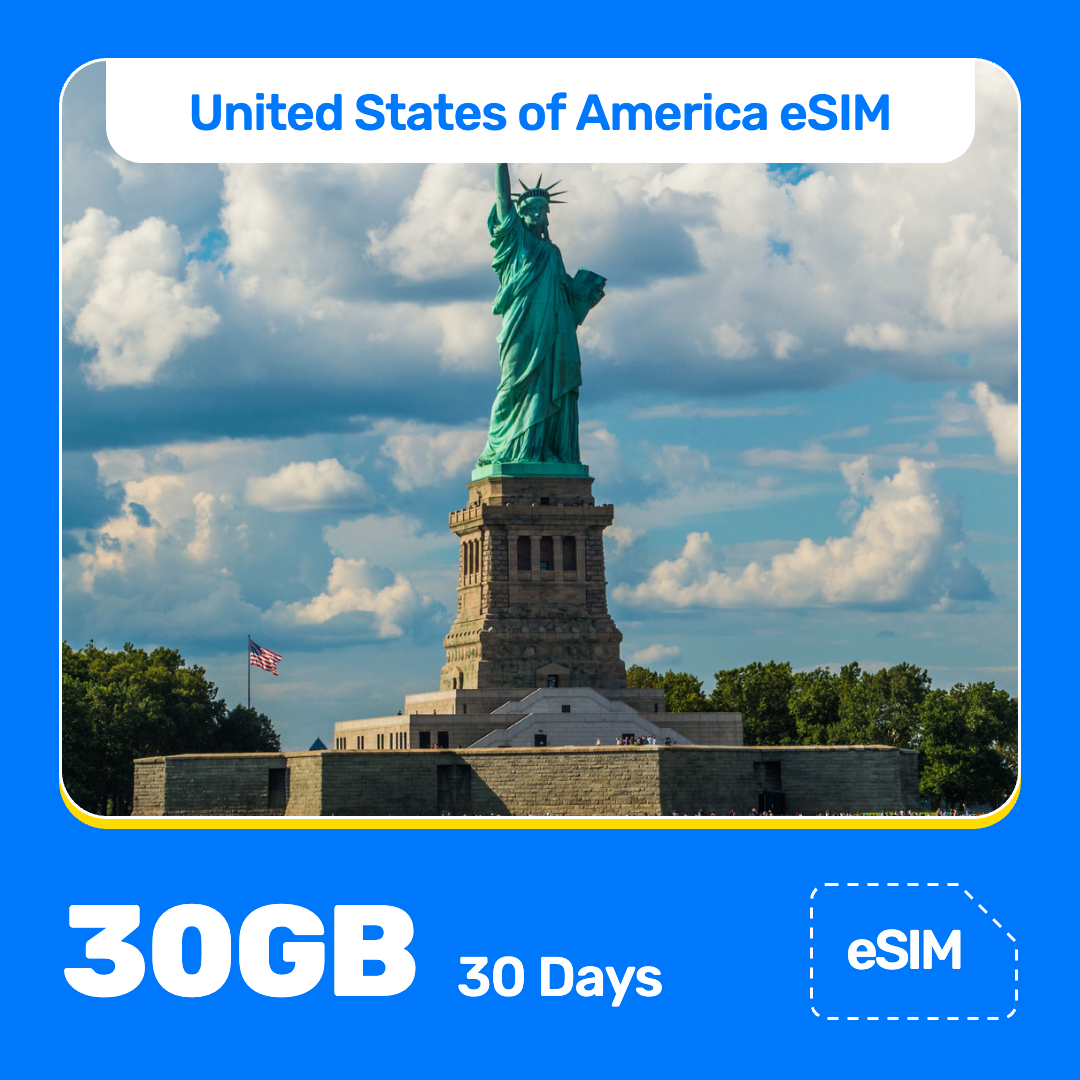 USA eSIM product banner featuring the Statue of Liberty on an island in New York Harbor on a sunny day, with visitors along the shore, and American flag nearby. Blue “USA eSIM” text appears at the top, with large white “30GB for 30 Days” text at the bottom left and an “eSIM” label at the bottom right.
