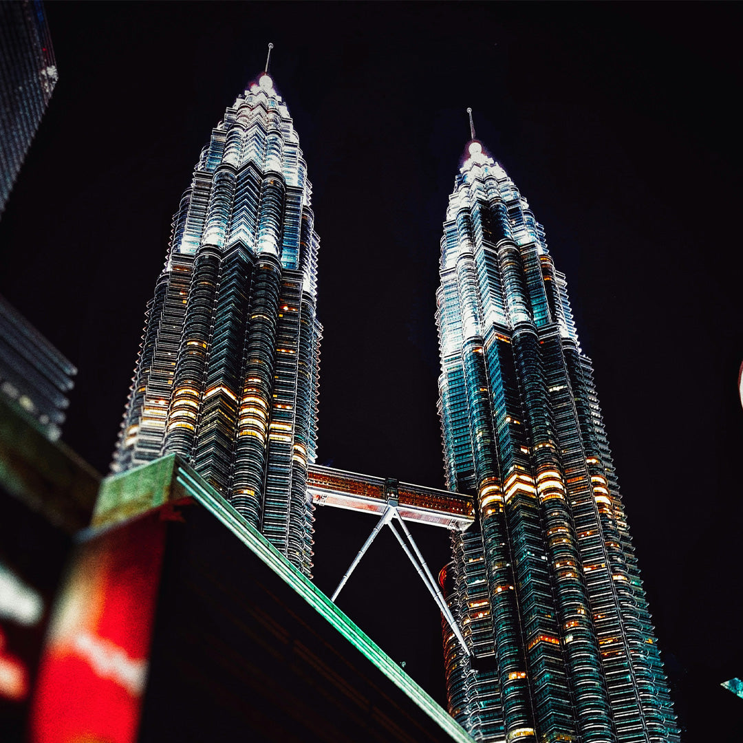 The Petronas Twin Towers in Kuala Lumpur against the night sky.